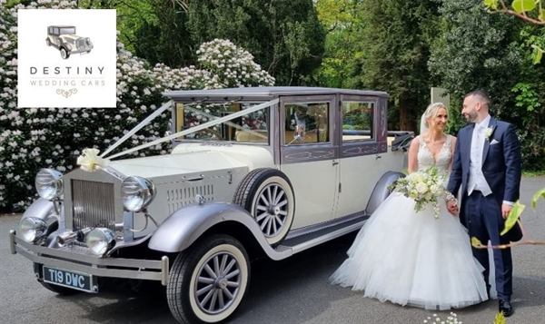 Tia, the ivory and silver wedding car, with a bride and groom